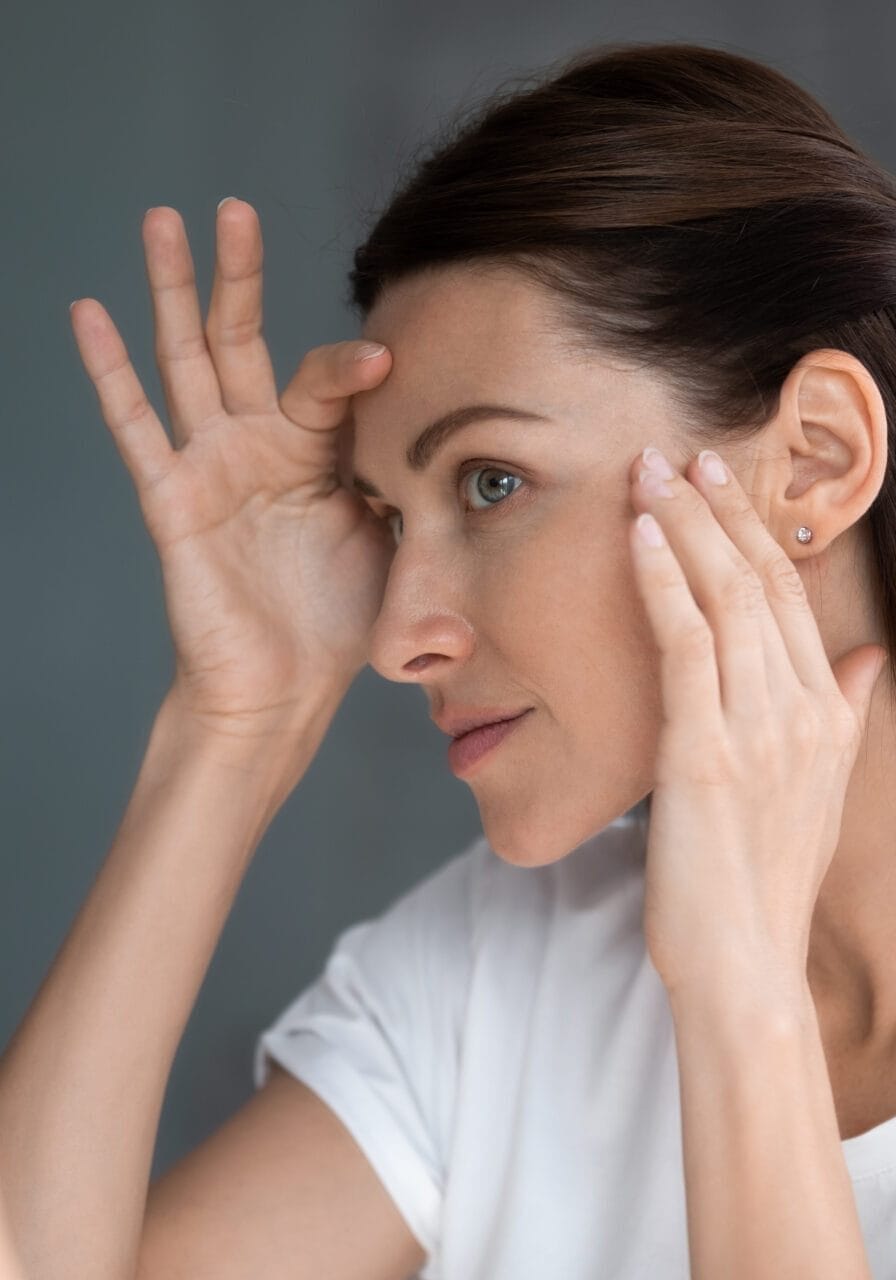 Close,Up,Of,Woman,Looking,In,Mirror,Check,Face,After